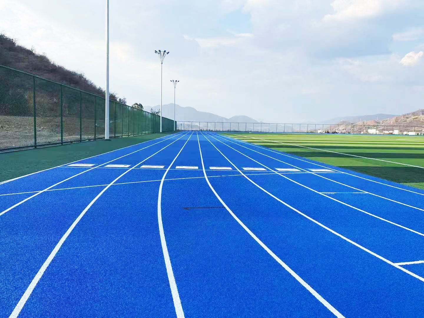 Hybrid athletic running track surface for stadium and school sports fields